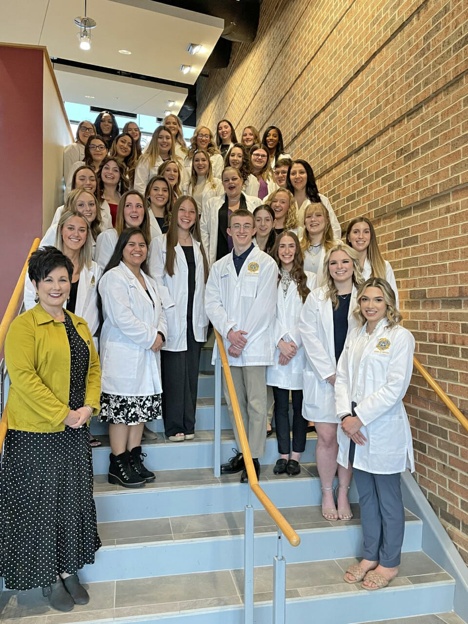 Photo of nursing students and White Coat Ceremony speaker posing on steps in Erma Ora Byrd Hall.