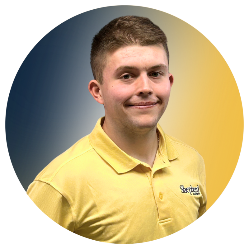 A-Team member Tyler wearing his A-Team yellow polo.