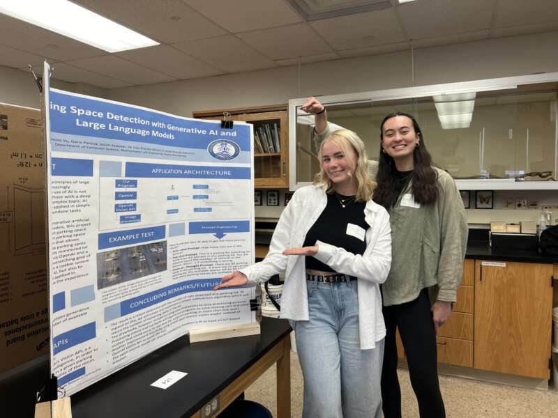 Cameron and Daria presenting a poster