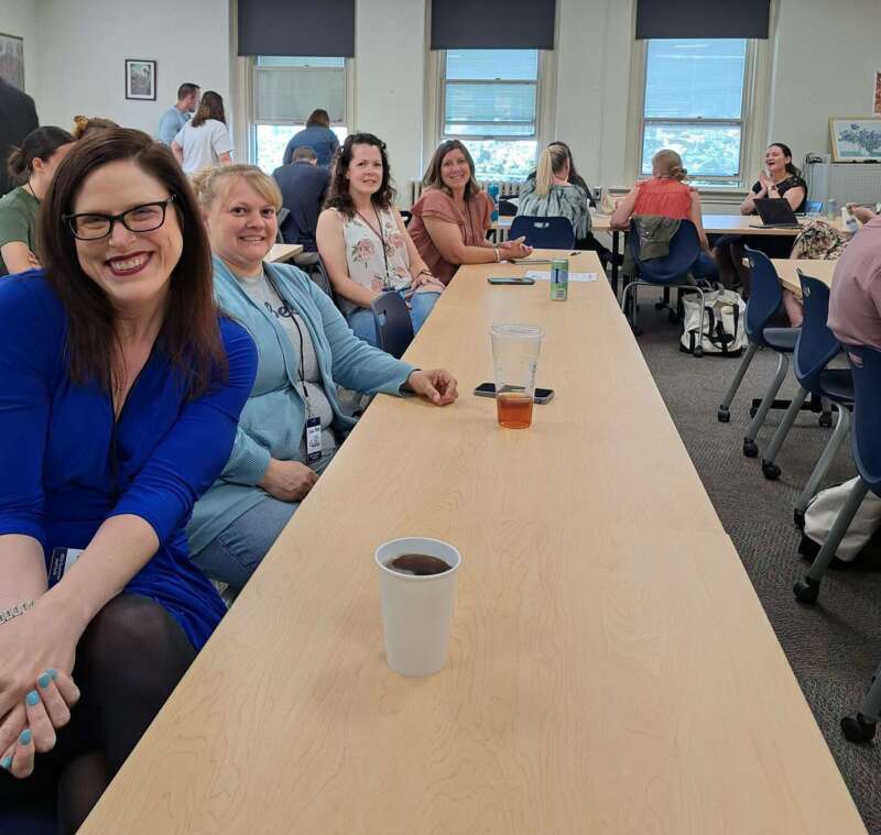 Graduate students sitting at a long table.